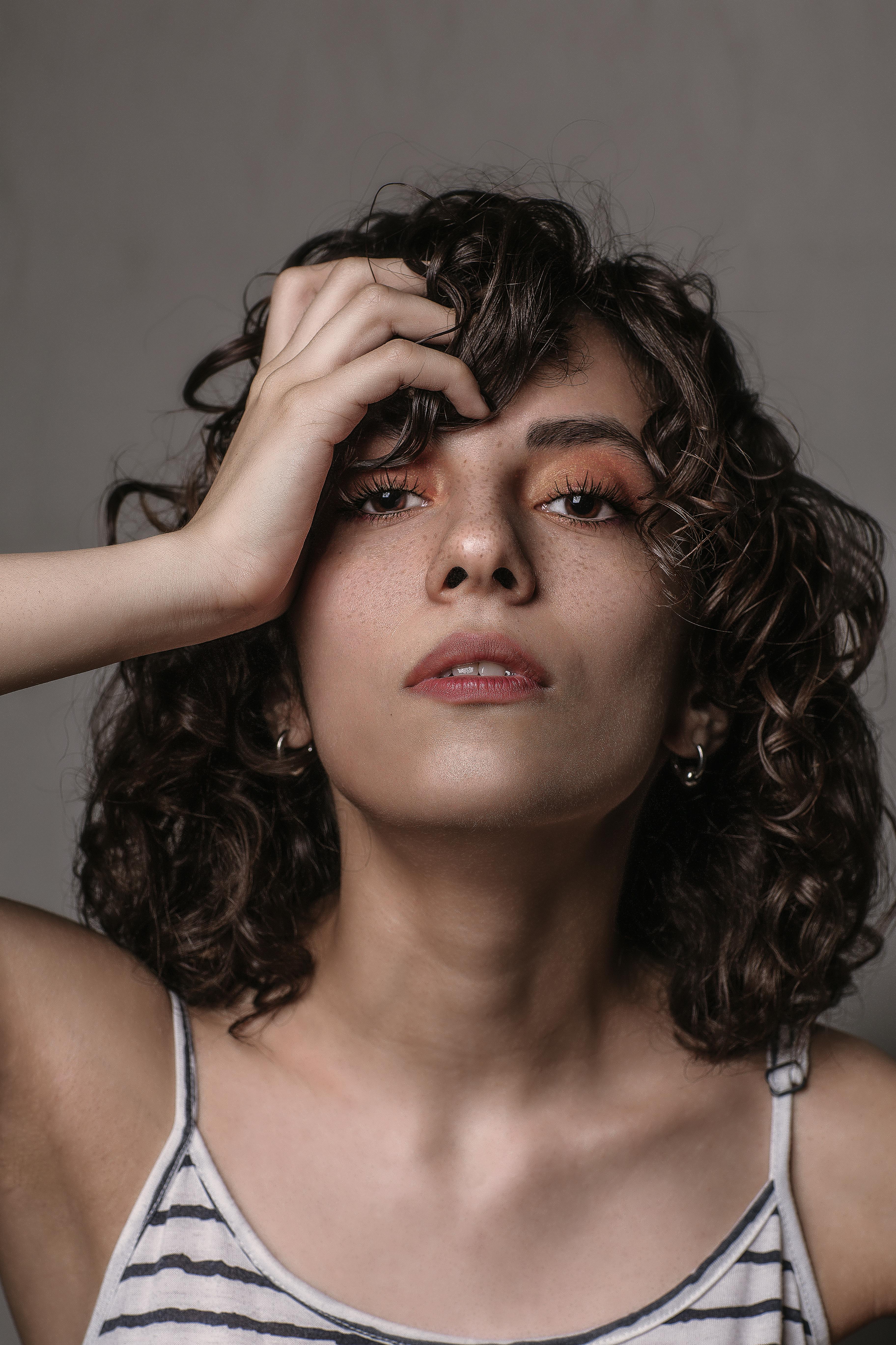 headshot of a woman 
					with curly brown hair